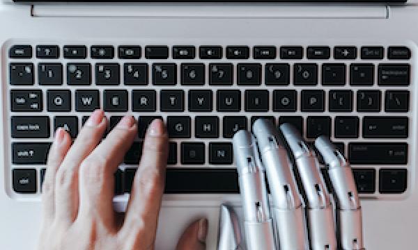 Robotic hand on laptop 